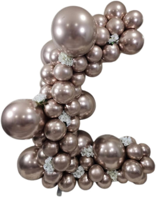 Rose gold balloon arch with decorative flowers on a white background